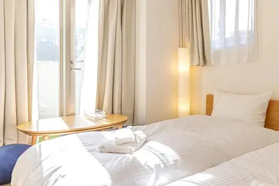 a hotel room with a bed and a table and a window at SQ312-5 mins Shibuya Station JR Yamanote - Max 2 in Tokyo