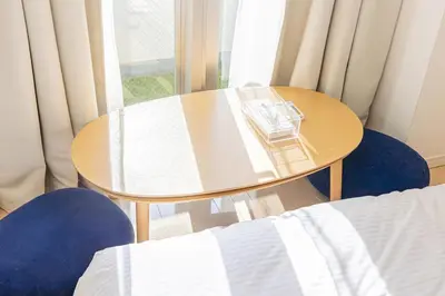 a table with a book on it next to a window at SQ312-5 mins Shibuya Station JR Yamanote - Max 2 in Tokyo