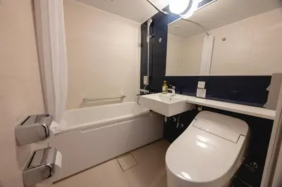 a bathroom with a white toilet and a sink at Hotel Mariners Court Tokyo in Tokyo