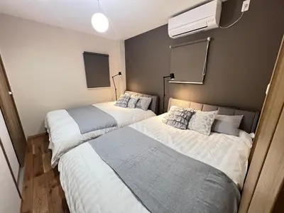 a bedroom with two beds and a air conditioner at New open ikebukuro Fangfun3 in Tokyo