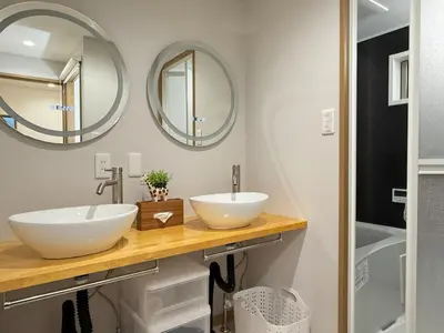 a bathroom with two sinks and two mirrors at New open ikebukuro Fangfun3 in Tokyo