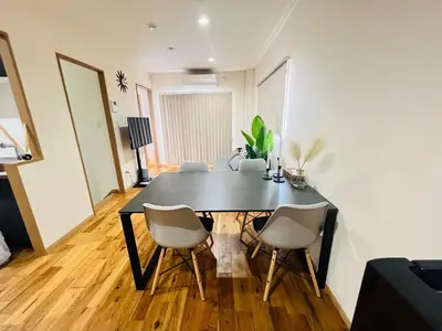 a dining room with a black table and chairs at New open ikebukuro Fangfun3 in Tokyo