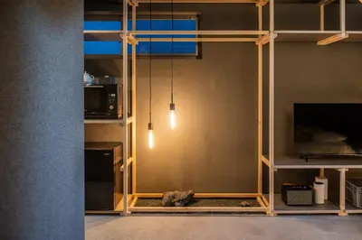 a living room with a wall with ajar at Mi-Kan Design Hotel in Tokyo