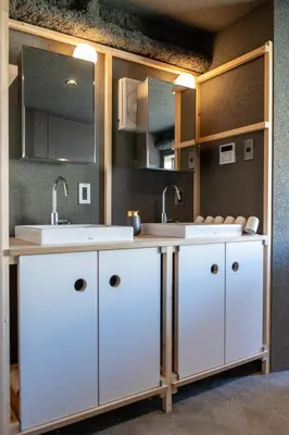 a kitchen with white cabinets and two sinks at Mi-Kan Design Hotel in Tokyo