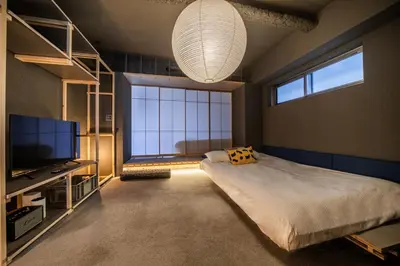 a bedroom with a large bed and a large window at Mi-Kan Design Hotel in Tokyo