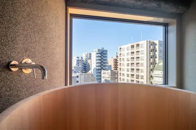 a bathroom with a large window and a large tub at Mi-Kan Design Hotel in Tokyo