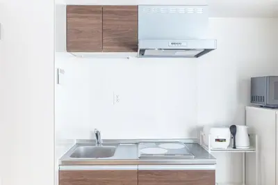 a small kitchen with a sink and a refrigerator at 67 Apt Waseda Shinjuku in Tokyo
