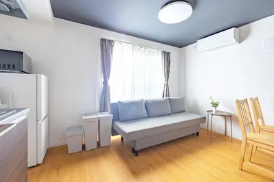 a living room with a couch and a window at 67 Apt Waseda Shinjuku in Tokyo