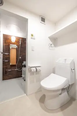 a white bathroom with a toilet and a shower at 67 Apt Waseda Shinjuku in Tokyo