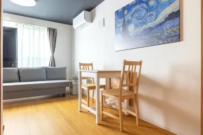 a living room with a table and chairs and a couch at 67 Apt Waseda Shinjuku in Tokyo