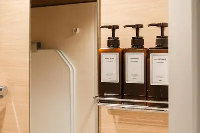 a row of bottles of soap sitting on a shelf at ROLES Ryusen 1001 in Tokyo