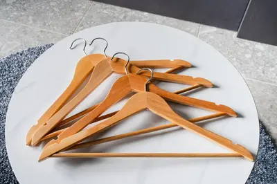 a pile of wooden hangers on a white plate at ROLES Ryusen 1001 in Tokyo