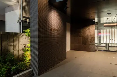 a hallway of a building with a brick wall at ROLES Ryusen 1001 in Tokyo