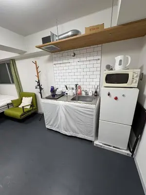 a small kitchen with a sink and a microwave at xinsuyuyuan in Tokyo