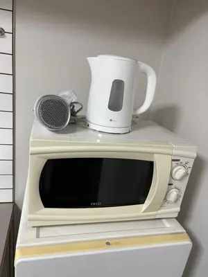 a microwave with a coffee pot on top of it at xinsuyuyuan in Tokyo