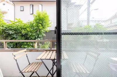 a bench sitting on a balcony next to a window at #3 \u65b0\u5bbf\u307e\u30672\u5206! \u6e05\u6f54\u3067\u5b89\u5168\u306a\u90e8\u5c4b! WiFi\u7121\u6599! in Tokyo
