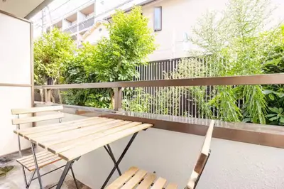 a wooden bench sitting on top of a balcony at #3 \u65b0\u5bbf\u307e\u30672\u5206! \u6e05\u6f54\u3067\u5b89\u5168\u306a\u90e8\u5c4b! WiFi\u7121\u6599! in Tokyo