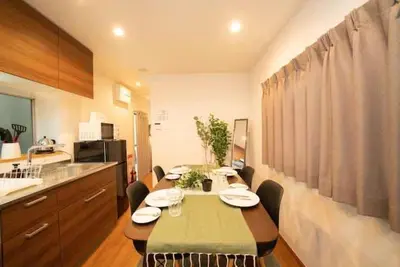 a kitchen with a table and chairs in a room at Shin-Nakano House in Tokyo