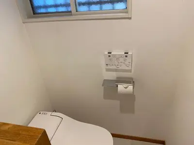 a small bathroom with a toilet and a window at Shin-Nakano House in Tokyo