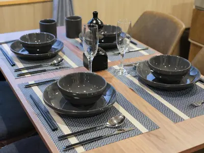 a table with black bowls and plates and wine glasses at \u30d5\u30ea\u30fc\u30b8\u30a2\u6d45\u8349stay in Tokyo