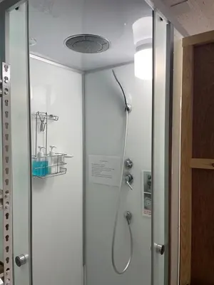 a shower in a bathroom with a glass door at Best location Private Kabukicho 2chome HigashiShinjuku Station 2min 58 m2 Super Convenient Shopping Gourmet Play in Tokyo