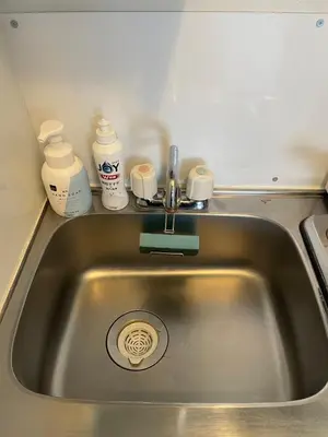 a kitchen sink with a faucet and cups on a counter at Best location Private Kabukicho 2chome HigashiShinjuku Station 2min 58 m2 Super Convenient Shopping Gourmet Play in Tokyo