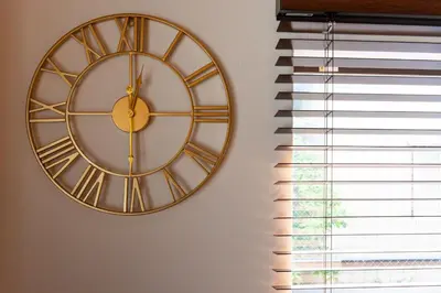 a gold clock on a wall next to a window at ONLY YOU HOTEL - Vacation STAY 02976v in Tokyo