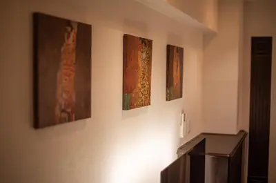 four paintings hanging on a wall in a room at Sun Mall Crest - Vacation STAY 18546 in Tokyo