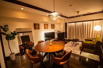 a living room with a wooden table and chairs at Sun Mall Crest - Vacation STAY 18546 in Tokyo