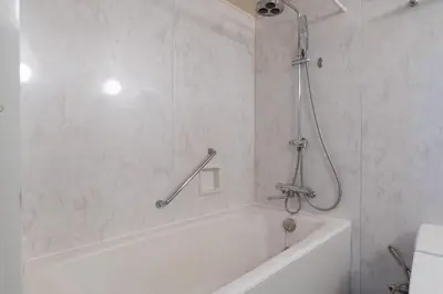 a white bathroom with a tub and a shower at \u5e83\u5c3e\u30a4\u30fc\u30b9\u30c8 in Tokyo
