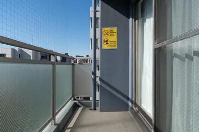 a balcony with a sign on the side of a building at \u5e83\u5c3e\u30a4\u30fc\u30b9\u30c8 in Tokyo