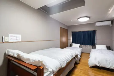 a hospital room with two beds and a window at The \u30cd\u30b3\u30b6\u30cd HAUS in Urayasu