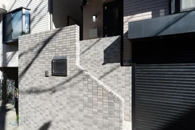 a brick building with a door and a window at The \u30cd\u30b3\u30b6\u30cd HAUS in Urayasu