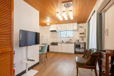 a living room with a flat screen tv on a wall at Asakusa4\u5206\u949f\u6674\u7a7a\u585410\u5206\u949f\u65e5\u5f0f\u6e29\u99a8\u548c\u5bbf201 MAX9\u4eba \u9ad8\u901fWIF in Tokyo