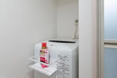a small refrigerator with a bottle of milk in it at Asakusa4\u5206\u949f\u6674\u7a7a\u585410\u5206\u949f\u65e5\u5f0f\u6e29\u99a8\u548c\u5bbf301 MAX9\u4eba \u9ad8\u901fWIF in Tokyo
