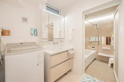 a white bathroom with a sink and a tub at Oasis Omori New House - 30min to Haneda - 2 Adjacent Homes in Tokyo