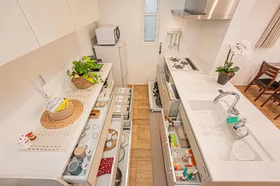 a kitchen with white counters and an open refrigerator at Oasis Omori New House - 30min to Haneda - 2 Adjacent Homes in Tokyo