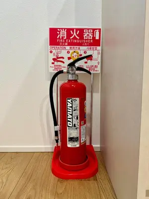 a red fire hydrant sitting on a wooden floor at Oasis Omori New House - 30min to Haneda - 2 Adjacent Homes in Tokyo
