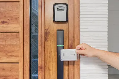 a hand is unlocking a door with a thermometer at Oasis Omori New House - 30min to Haneda - 2 Adjacent Homes in Tokyo