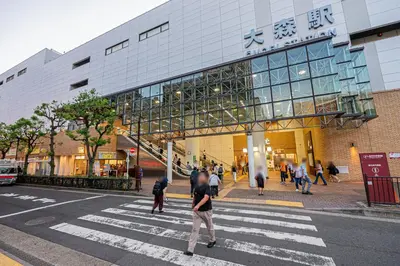 a group of people crossing a street in front of a building at Oasis Omori New House - 30min to Haneda - 2 Adjacent Homes in Tokyo