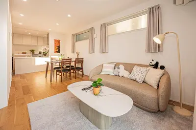 a living room with a couch and a table at Oasis Omori New House - 30min to Haneda - 2 Adjacent Homes in Tokyo