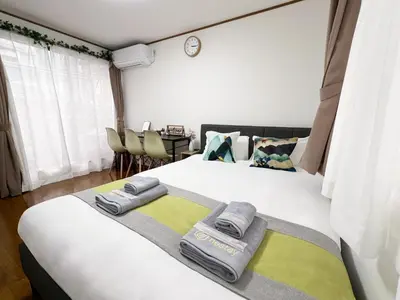 a bedroom with a bed with two towels on it at nestay villa tokyo akasaka in Tokyo