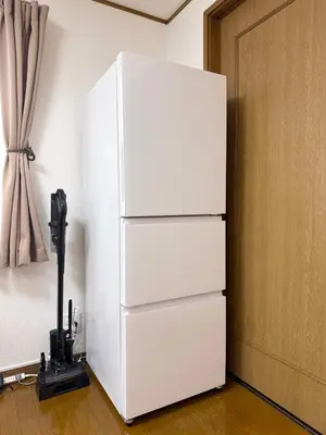a white refrigerator in a room with a camera at nestay villa tokyo akasaka in Tokyo