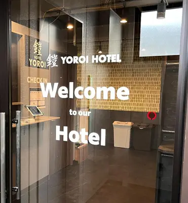 a welcome to our hotel sign on a glass door at Yoroi Asakusa Hotel in Tokyo