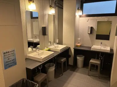 a bathroom with two sinks and two mirrors at Yoroi Asakusa Hotel in Tokyo