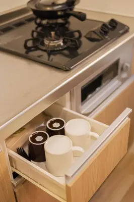 a kitchen drawer with cups and a stove at SUNRISE STAY Asakusa in Tokyo