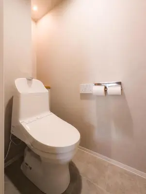 a bathroom with a toilet and two rolls of toilet paper at SUNRISE STAY Asakusa in Tokyo