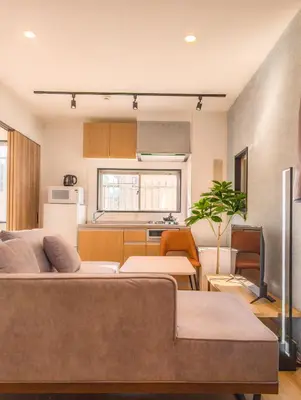 a living room with two beds and a kitchen at SUNRISE STAY Asakusa in Tokyo