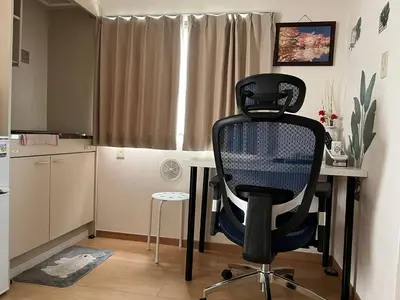 a black chair sitting at a desk in a kitchen at kitashijyuku in Tokyo