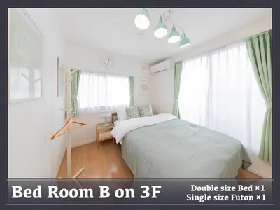 a bedroom with a bed in a room with windows at Horikiri House, 3-story home, 15 guests, Free parking, 103sqm in Tokyo